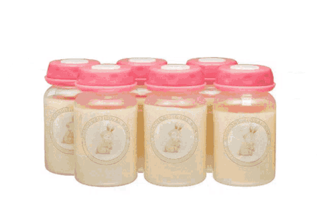 a row of baby bottles with pink lids and labels that say baby bottles on them