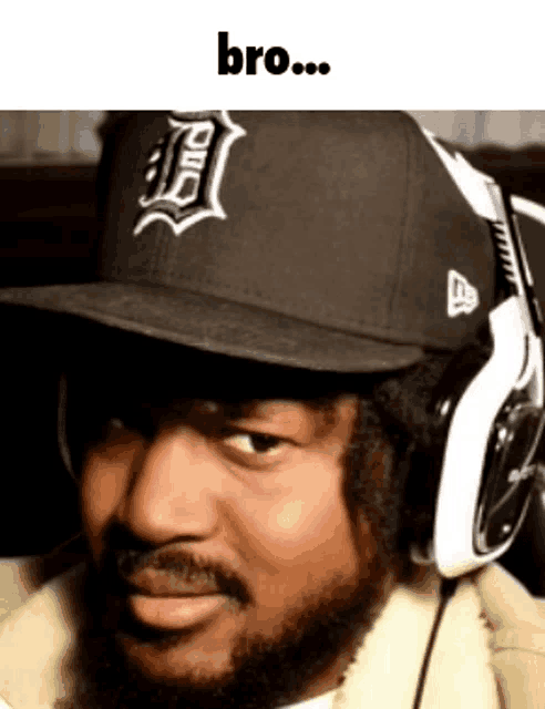 a man with a beard wearing headphones and a hat with the word bro on it
