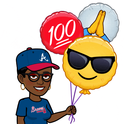a woman in a braves shirt holds balloons in her hand