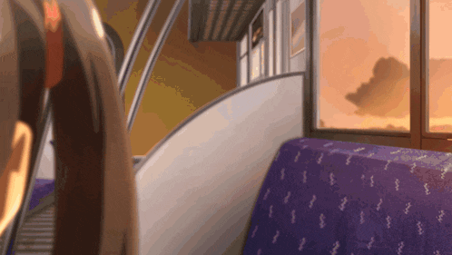 a blurry picture of a person walking up stairs with a purple seat in the foreground