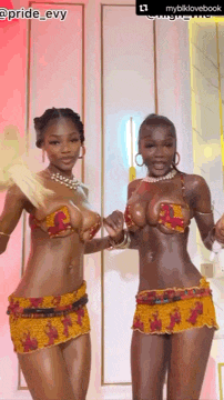 two women in bikinis are standing next to each other and dancing .