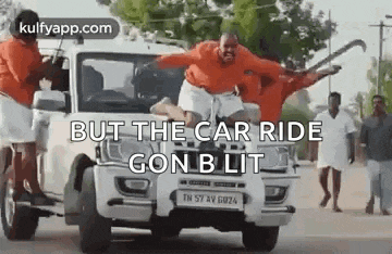 a group of people are jumping out of a car .