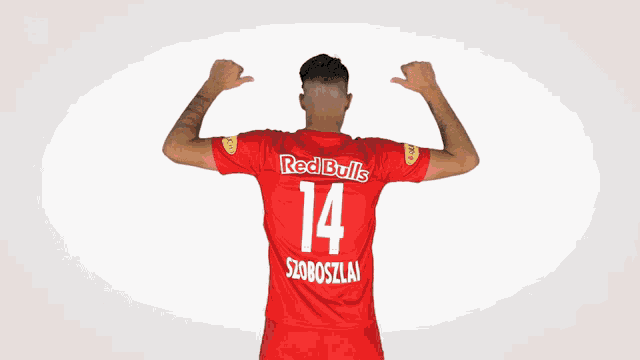 a man is wearing a red bulls jersey with the number 14 on it