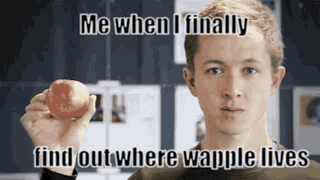 a man is holding an apple in his hand with the caption me when i finally find out where waffle lives