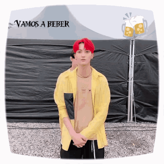 a man in a yellow shirt is standing in front of a tent with the words vamos a beber written above him
