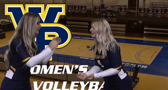 two female volleyball players giving each other a fist bump