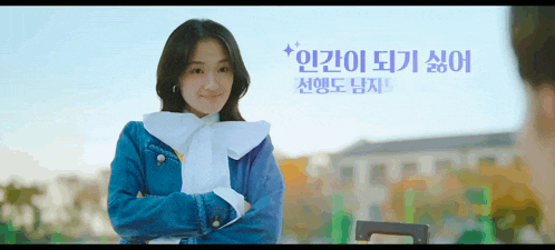 a woman in a blue jacket with a white bow on her neck