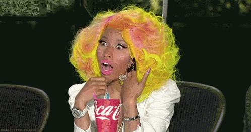 a woman with yellow hair is drinking a coca cola