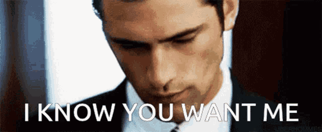 a man in a suit and tie is looking down and says `` i know you want me '' .