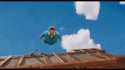 a man in a blue shirt is flying in the air
