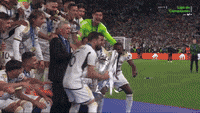 a group of soccer players are celebrating on the field and one of them has the number 10 on his shirt