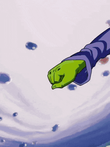 a person 's hand is holding a green object