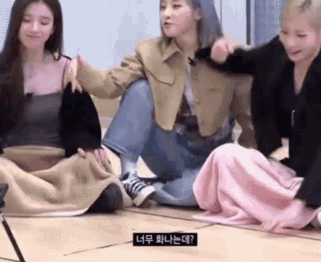 a group of girls are sitting on the floor with blankets around their waists