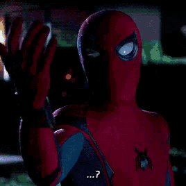 a close up of a spider man 's face with a question mark on it