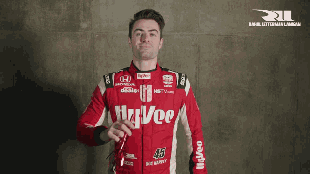 a man wearing a red race suit with the number 43 on the front