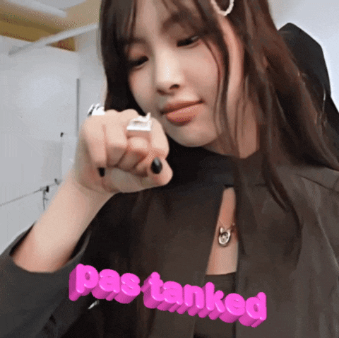 a woman is pointing at the camera with the words pas tanked in pink