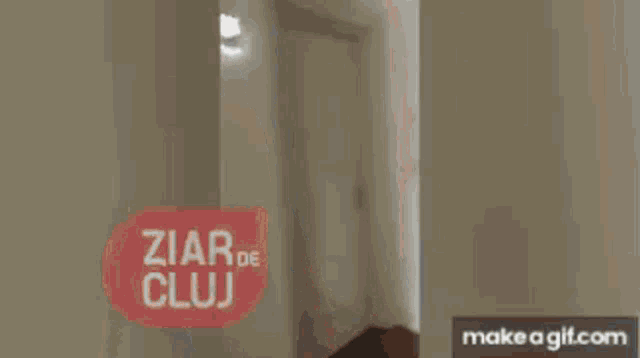a room with a sign that says ziar de cluj on it .
