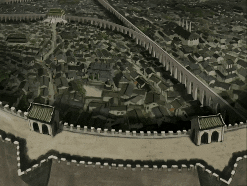 an aerial view of a city with a wall and arches