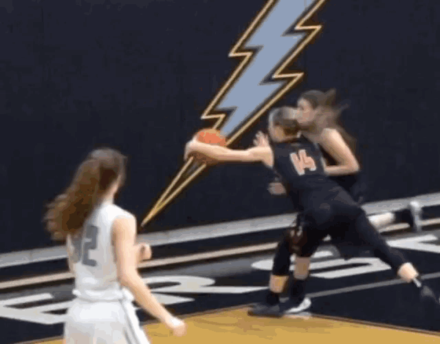 a female basketball player wearing a jersey with the number 12 on it