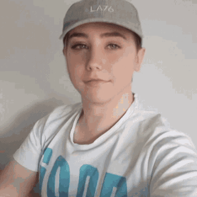 a man wearing a la76 hat and a white shirt