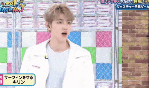 a man in a white jacket stands in front of a sign that says no. 1