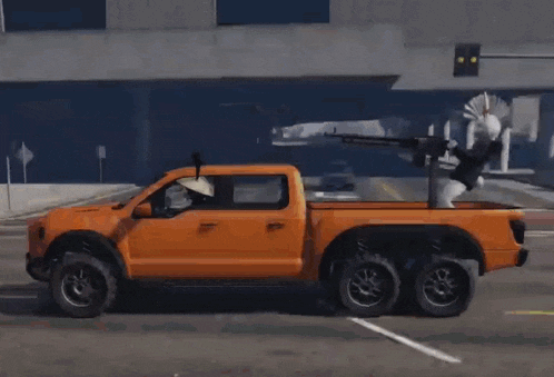 a truck with a cheerleader on the back of it is driving down a street .