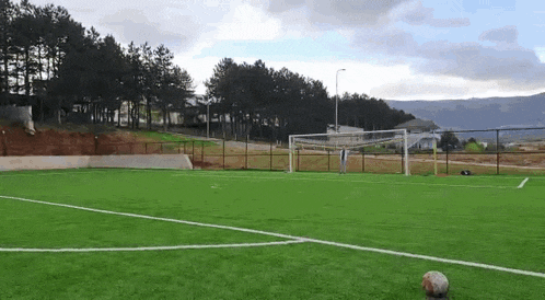 a soccer ball is on the edge of a soccer field .
