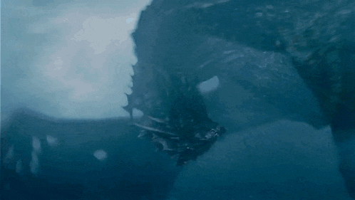a close up of a dragon 's head with a blue background