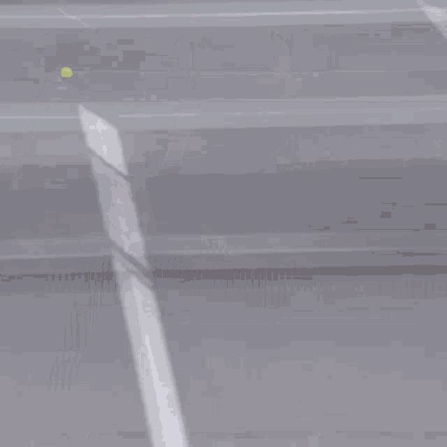 a man is playing tennis on a court with a sign that says " we are mattress "