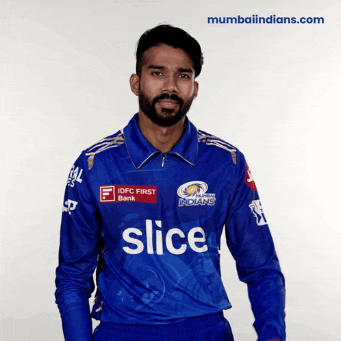 a man wearing a blue shirt with slice on it
