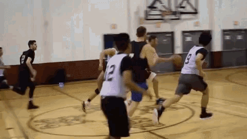 a group of basketball players are playing on a court and one of them has the number 12 on his jersey