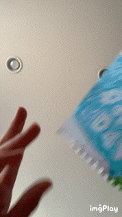 a person 's hand is holding a piece of paper that says ' i love you ' on it