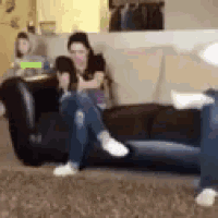 a woman is sitting on a couch with her legs crossed .