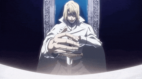 a man is sitting in a chair with his hands folded in front of him