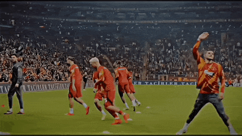 a group of soccer players on a field with a banner that says er tacirler