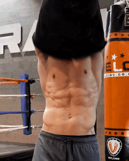 a man in a boxing ring with a bag that says elc on it