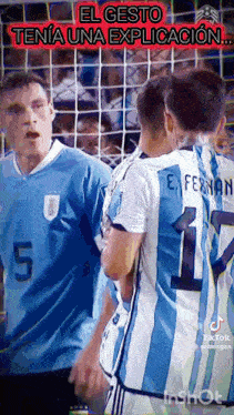 a group of soccer players are standing next to each other .
