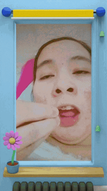 a picture of a woman 's face is framed by a yellow curtain