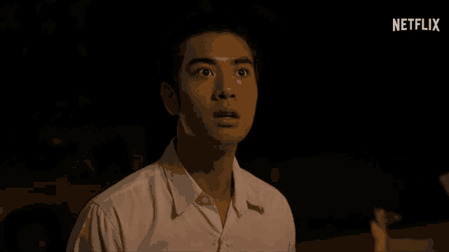 a man in a white shirt is standing in the dark with a netflix logo in the corner