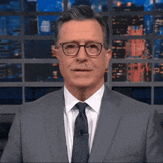 a man wearing glasses and a suit and tie