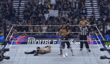 wrestlers in a ring with a sign that says double e
