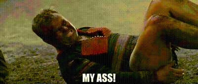 a man is laying on the ground with blood on his face and the words `` my ass '' .