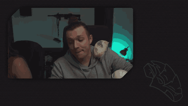 a man sitting in a chair with a stuffed animal on his shoulders
