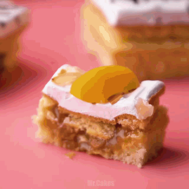a piece of cake with a slice of peach on top and the words mr.cakes below it