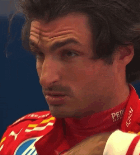 a man is wearing a red jacket with santander written on it
