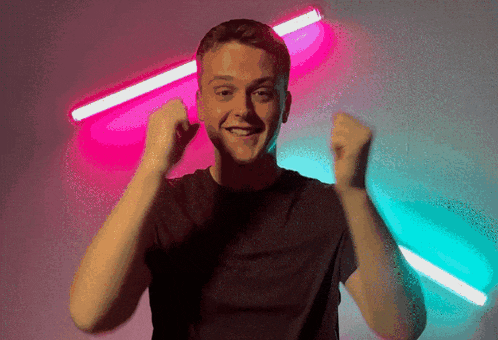 a man in a black shirt is making a fist gesture