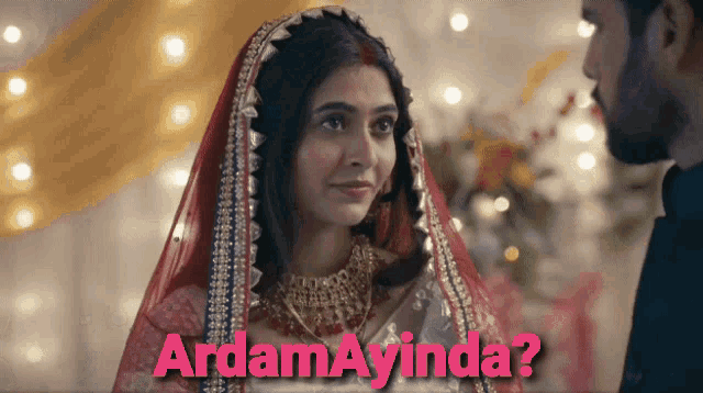 a man and a woman are standing next to each other with the words ardam ayinda written above them
