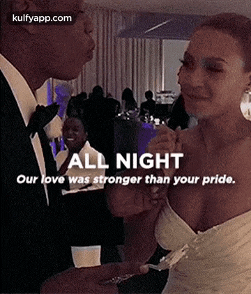 a man and a woman are standing next to each other at a party .