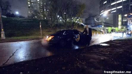 a gif of a car driving down a street at night
