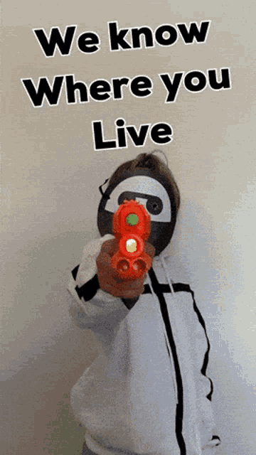 a person holding a toy gun with the words we know where you live on the bottom